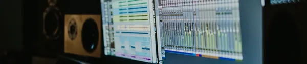 Computer monitors running a recording session inside a studio