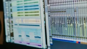 Computer monitors running a recording session inside a studio