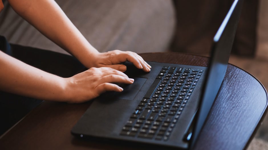 Producer checking the licence terms of a free beat on a laptop