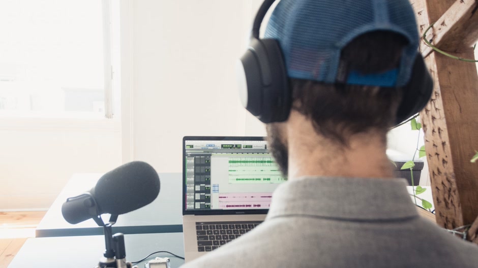 Producer listening on headphones in a studio