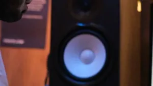 Producer working at a desk in front of studio monitors