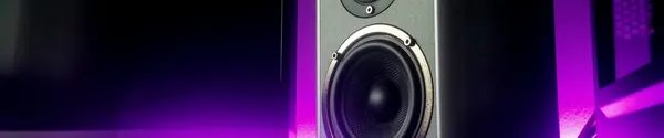 Close up of a studio monitor speaker in a dark room