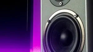Close up of a studio monitor speaker in a dark room