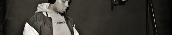 Rapper standing in front of a studio microphone