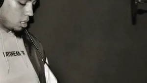 Rapper standing in front of a studio microphone