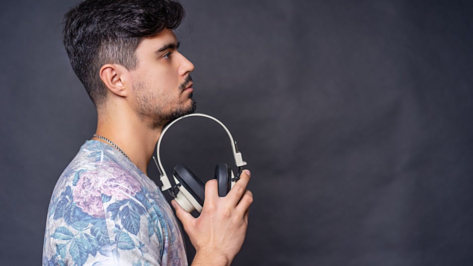 Producer listening closely to a beat with studio headphones