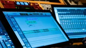 Producer working at a DAW in a dark studio, the kind of session an AI beat cannot fake