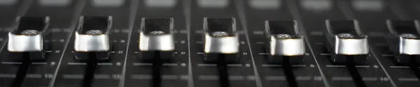 Channel faders on a mixing console, close up