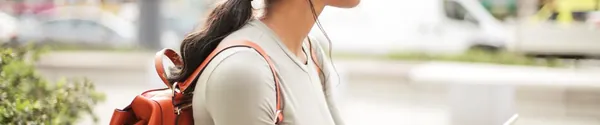 Woman listening to music on her phone with headphones