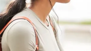 Woman listening to music on her phone with headphones