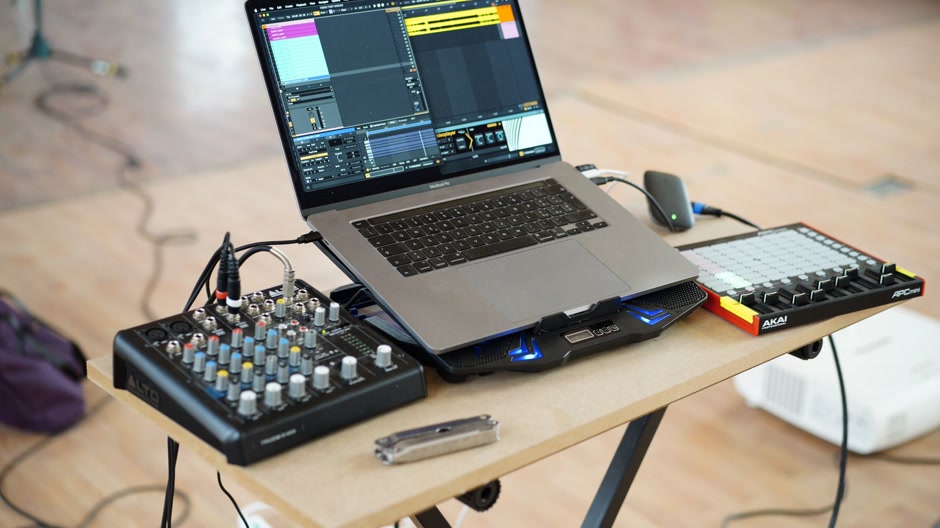 Laptop and audio interface on a studio desk at night