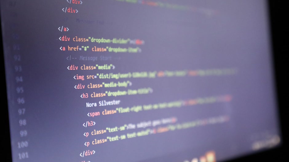 HTML code on a dark monitor, the cart logic being written
