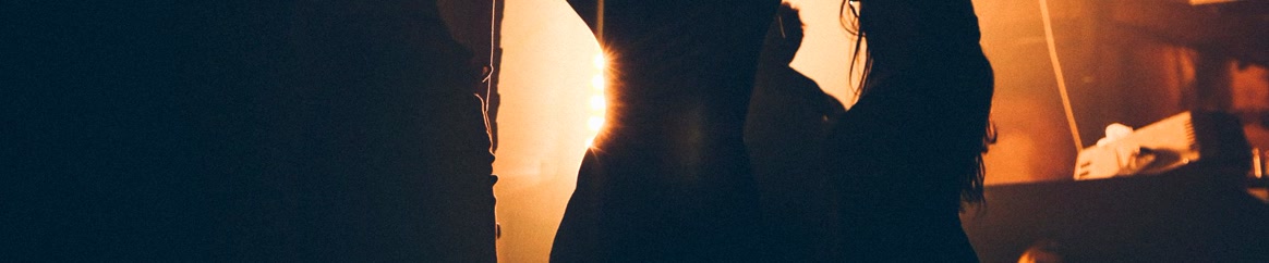 People dancing in a club under warm lights