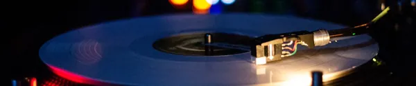A turntable playing a vinyl record in a dark room