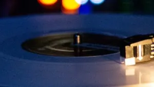 A turntable playing a vinyl record in a dark room