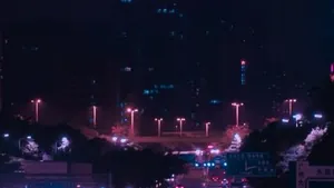 Car lights streaking through a dark street at night